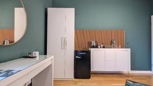 a kitchen with a black refrigerator and a counter at 3 ROOMS - Zimmervermietung nähe Flughafen BER - gratis WLAN, Parken & Netflix in Berlin