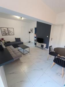 a living room with a couch and a table at Alexander apartments in Spartia