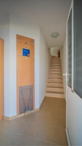 a hallway with a staircase and a stair case at Apartmani Ana in Tivat