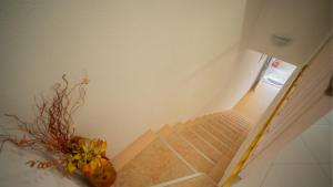 a stairway with a vase of flowers on the floor at Apartmani Ana in Tivat