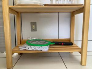 a wooden shelf with a mop and dishes on it at Casa Completa e Bem Localizada in Parnaíba