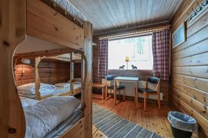 a bedroom with a bunk bed and a desk at Försgården Fjällpensionat in Transtrand