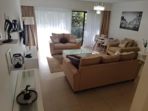 a living room with two couches and a table at Astoria Luxury Apartments, Lavington in Nairobi