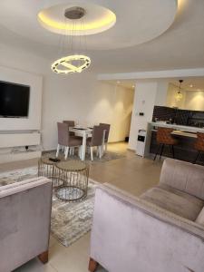 a living room with a couch and a table at Astoria Luxury Apartments, Lavington in Nairobi