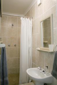 a bathroom with a white shower curtain and a sink at Cozy Crner, home away from home, near from pristine beaches num2 in Langebaan +7 photos