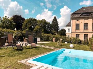 a swimming pool in the yard of a house at Villa Hänsch Suite 1 in Großschönau