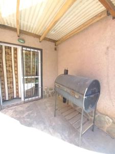 a bbq grill sitting outside of a building at Tantanakuy in Villa General Belgrano