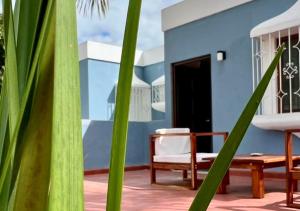 a patio with a bench and a chair and a house at Casa Ekinox in Petkanché