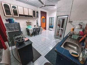 a kitchen with a sink in the middle of a room at SM VILLA LANGKAWI full privacy home with pool in Kuah