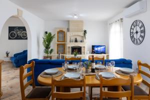 a dining room with a table and a blue couch at Villa in St Julian's with Private Pool in St Julian's