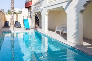 a swimming pool with blue water in a house at Villa in St Julian's with Private Pool in St Julian's