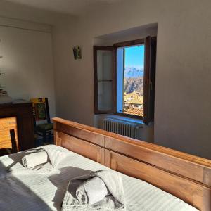 a bedroom with a bed and a window at Appartamento soleggiato con vista panoramica - Via Rinaldi in Arto Centonara
