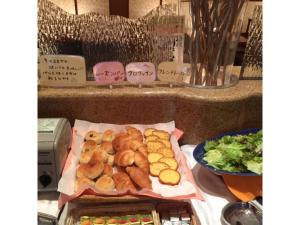 a table with a tray of pastries and a bowl of salad at Aeria Tohno - Vacation STAY 62232v in Tōno