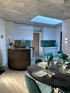 a kitchen and dining room with a table and chairs at All'eau Turquoise 
