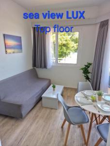 a small room with a bed and a table at BLUE EYES APARTMENTS in Ixia