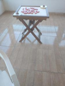 a wooden table with food on it on a floor at Cantinho da paz jesus nazareno in Gamela