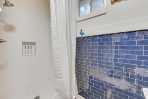 a bathroom with blue tile on the wall at Baton Rouge Cottage with Fenced Yard Near Downtown! in Baton Rouge +17 photos