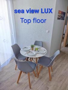 a table and chairs in a room with a sign at BLUE EYES APARTMENTS in Ixia +53 photos