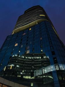 um edifício alto à noite com as luzes acesas em King David Residence Tbilisi - 2 Bedroom Luxury Apartment em Tbilisi