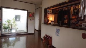 a living room with a large window and a lamp at Lilac Hotels and Resorts - Vacation STAY 53215v in Kanoya