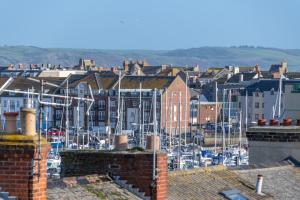 a view of a city with houses and boats at Home & A'Wey - Holiday home near harbour in Weymouth