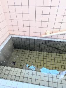 a bathroom with a tub with a tiled floor at cheer house - Vacation STAY 59869v in Shikyū