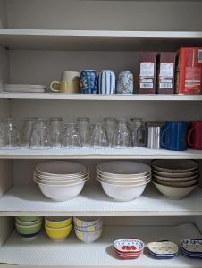 a shelf filled with bowls and plates and cups at cheer house - Vacation STAY 59869v in Shikyū