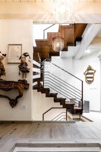 a spiral staircase in a living room with a chandelier at Casa Tarducci in Urbania