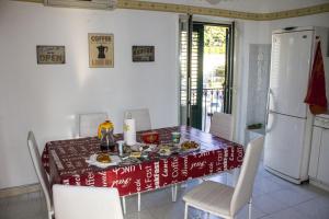 a dining room with a table and chairs and a refrigerator at B&B Porta Nuova in Palermo