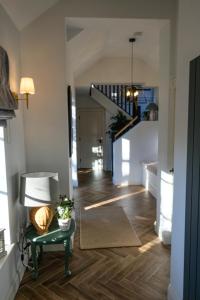 a living room with a table and a staircase at Mary's Lane in Randalstown