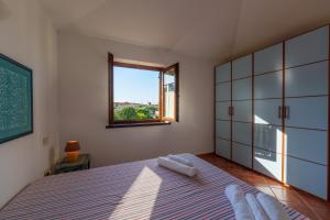 a bedroom with a large bed and a window at Appartamento Figari in Golfo Aranci