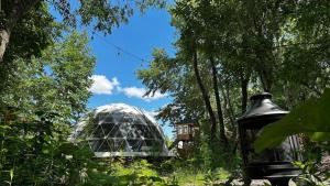 a glass greenhouse in the middle of a garden at Asahikawa City - Camp - Vacation STAY 62748v in Chikabumichō