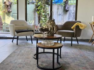 uma sala de estar com cadeiras, uma mesa e um vaso em Eco Horqueta em Boquete