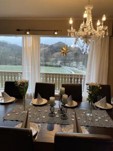 a dining room with a table and a large window at Kyrkjeneset in Bjerkreim