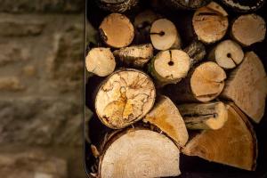 a pile of chopped wood sitting on a wall at Stunning Renovation edge of Frome + country views in Frome