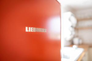 a red door with the word refrigerator on it at Stunning Renovation edge of Frome + country views in Frome