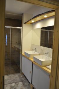 a bathroom with two sinks and a shower at Cataleya Rajcza in Rajcza