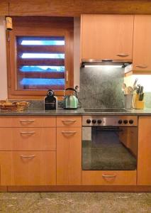 a kitchen with a stove and a sink and a window at Rustico Valgrazia in Molare