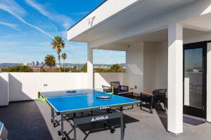 a ping pong table on the balcony of a house at Brand New 9 Modern Bedroom Compound in Pickfair Village in Los Angeles