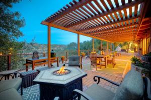 a patio with a table and a fire pit at City Getaway, Hot Tub, Fire Pit, Game Room, BBQ, Hiking Trails, Vineyard Views, B-Ball in Fallbrook