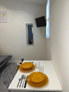 una mesa con dos placas amarillas encima en Charmant studio près de Roissy CDG, en Le Mesnil-Amelot