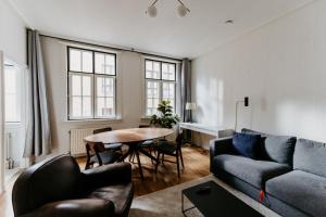 a living room with a couch and a table at Cathedral view apartment in Antwerp