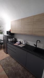 a kitchen with a black counter top and a sink at Plebiscito Suite Apartment in Naples