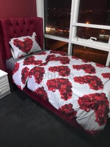 a bedroom with a bed with red roses on it at Paz Holiday Luxurious Space in Dubai