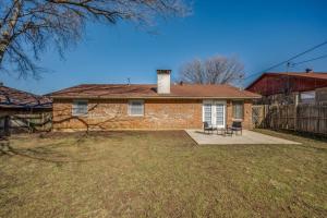 a brick house with a fence in a yard at Centrally Located 3BR 2BA - ! in Denton