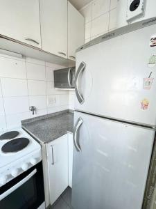 a kitchen with a white refrigerator and a stove at Apartamento en Belgrano in Buenos Aires