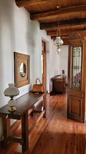 a large room with a wooden table and a tub at Casa Maca in Mendoza