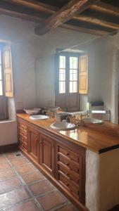 a bathroom with three sinks in a room at Casa Maca in Mendoza