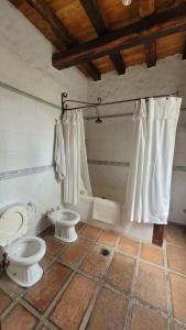 a bathroom with two toilets in a room at Casa Maca in Mendoza