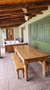 a wooden table in a room with a bed at Casa Maca in Mendoza